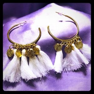Gold tone half hoop earring with tassels